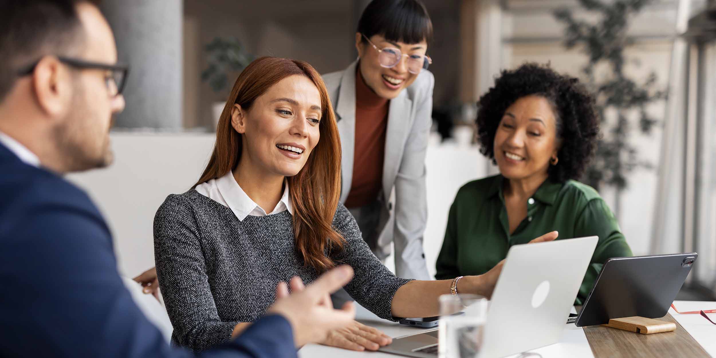 Office professionals exchange ideas during a collaborative meeting