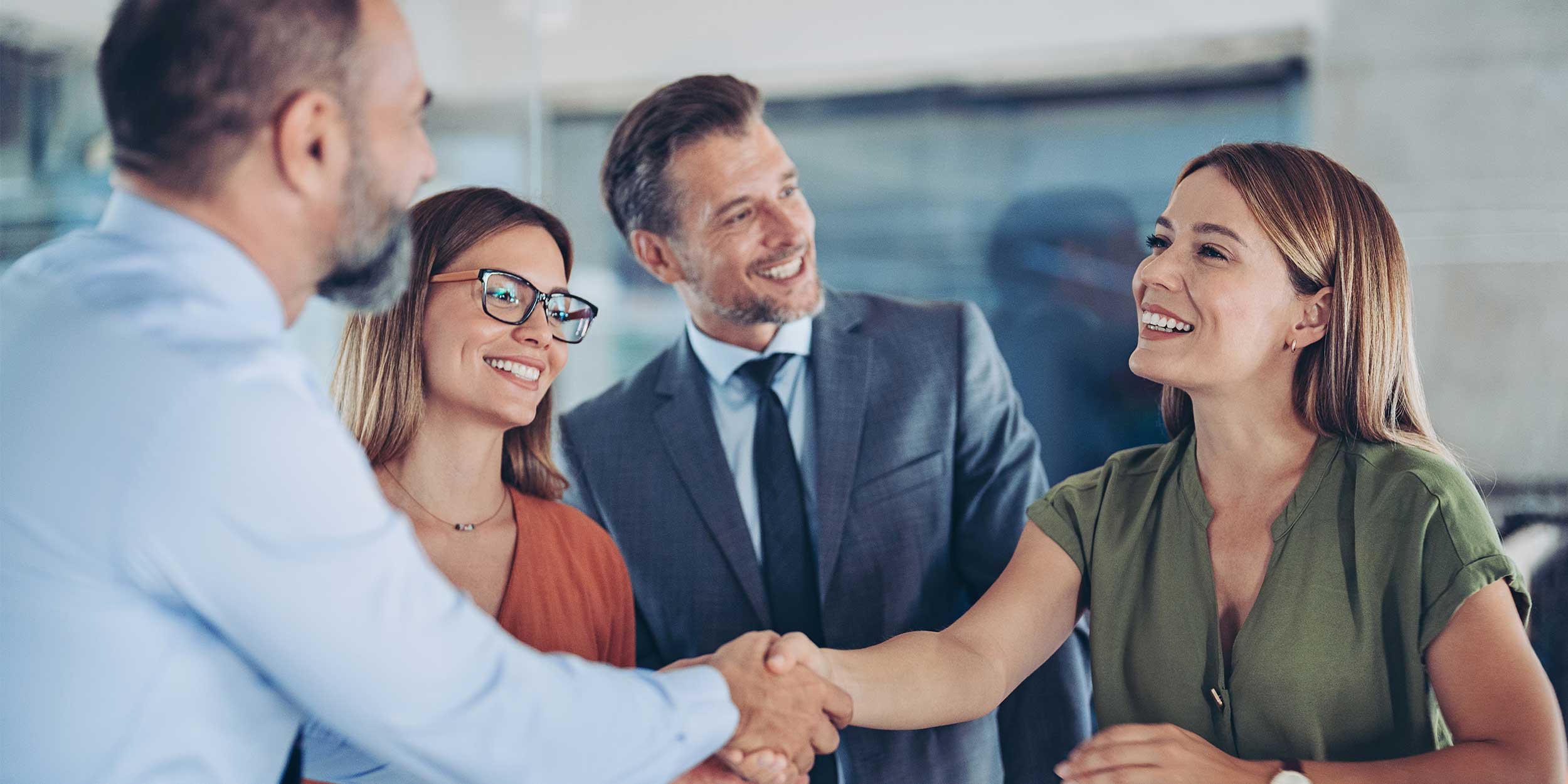Business persons shaking hands on a meeting