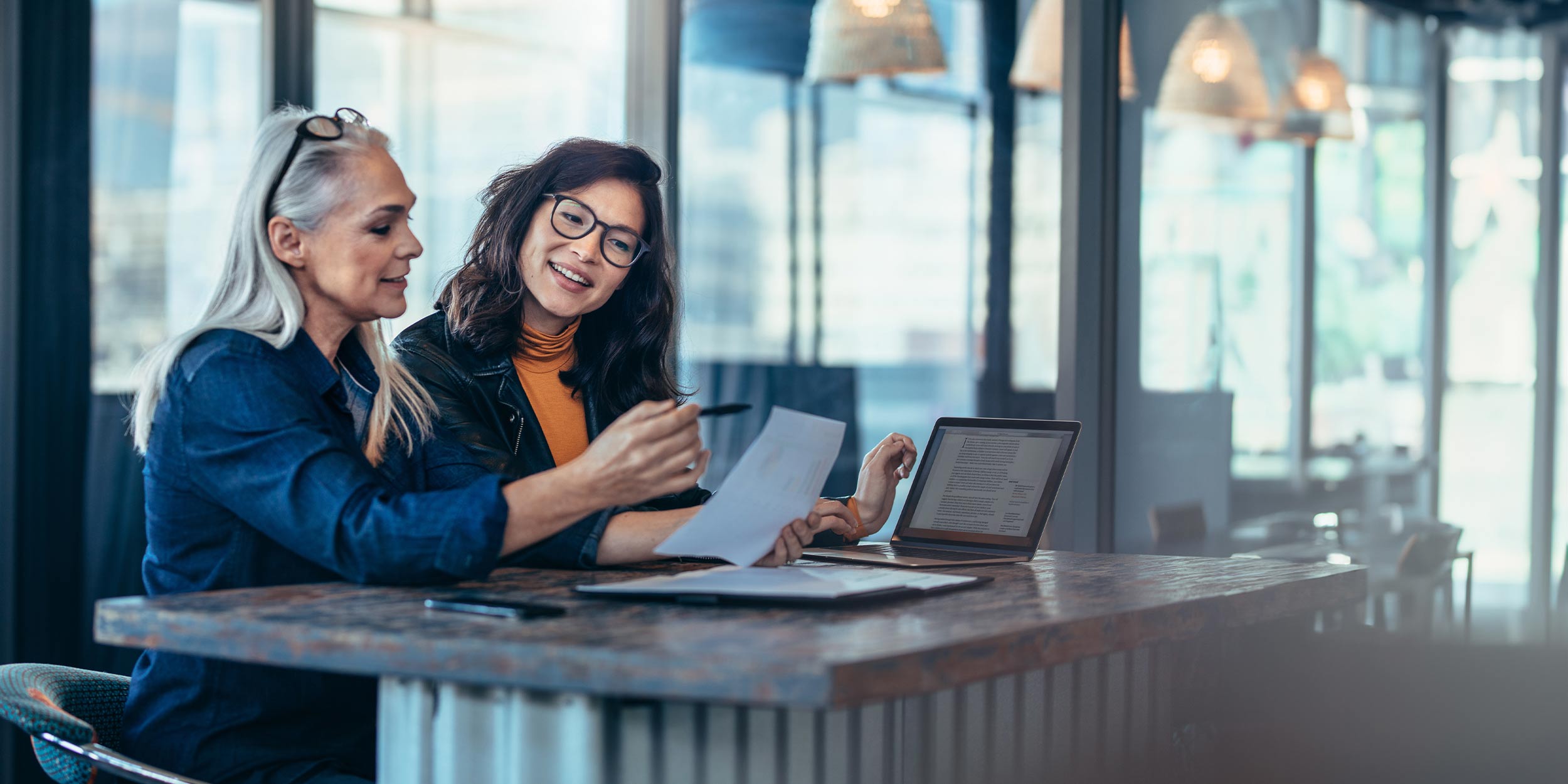 Two women working together at a desk