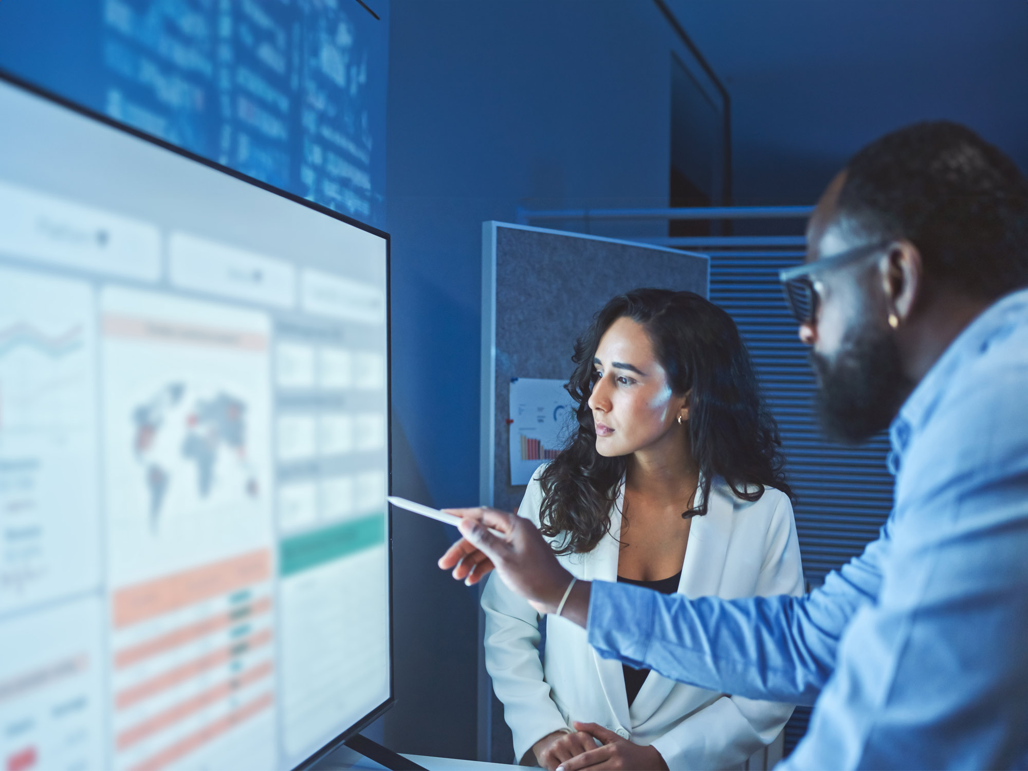 A team of multiethnic developers is meeting to review the data analysis of marketing from social media platforms