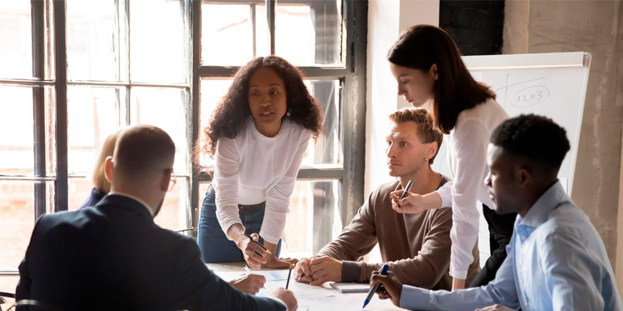 Group of people discussing project in meeting room