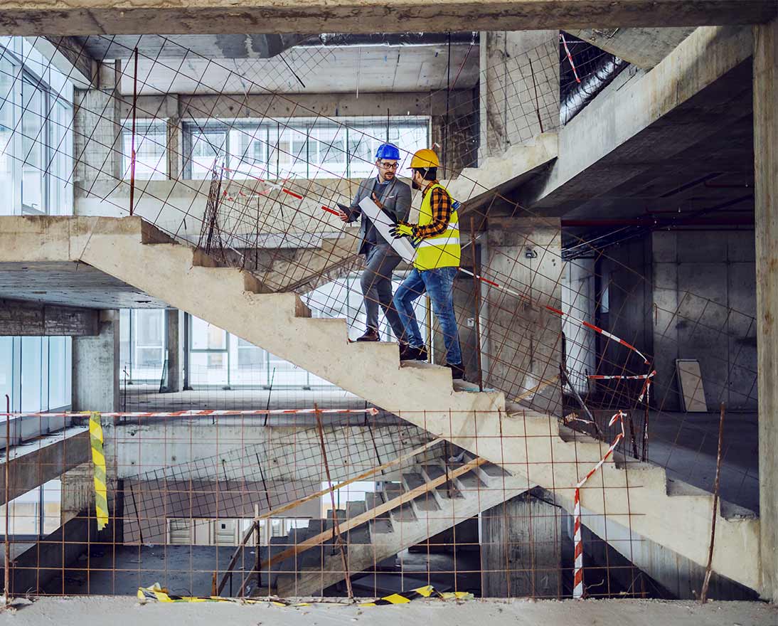 workers walking stairs on construction site