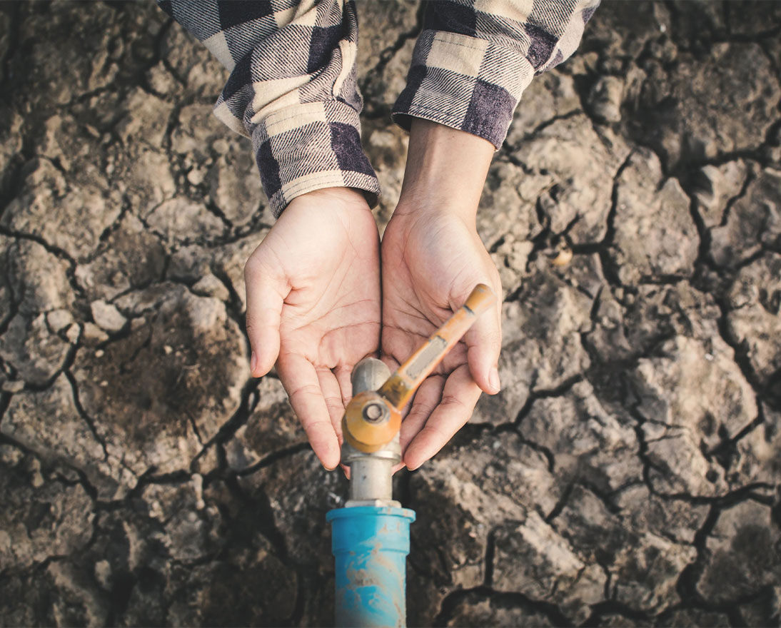 a person holding out hands under a tap