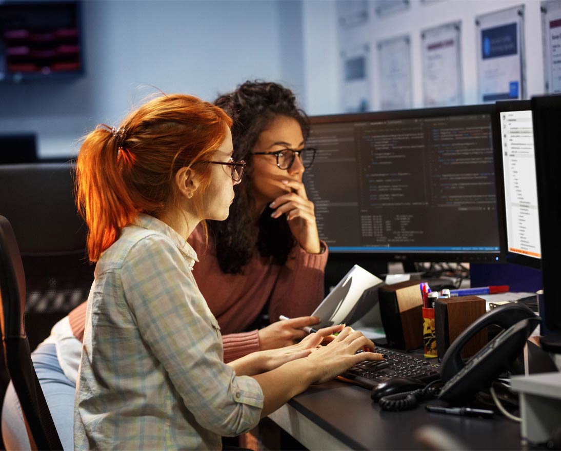Two female programmers working on project