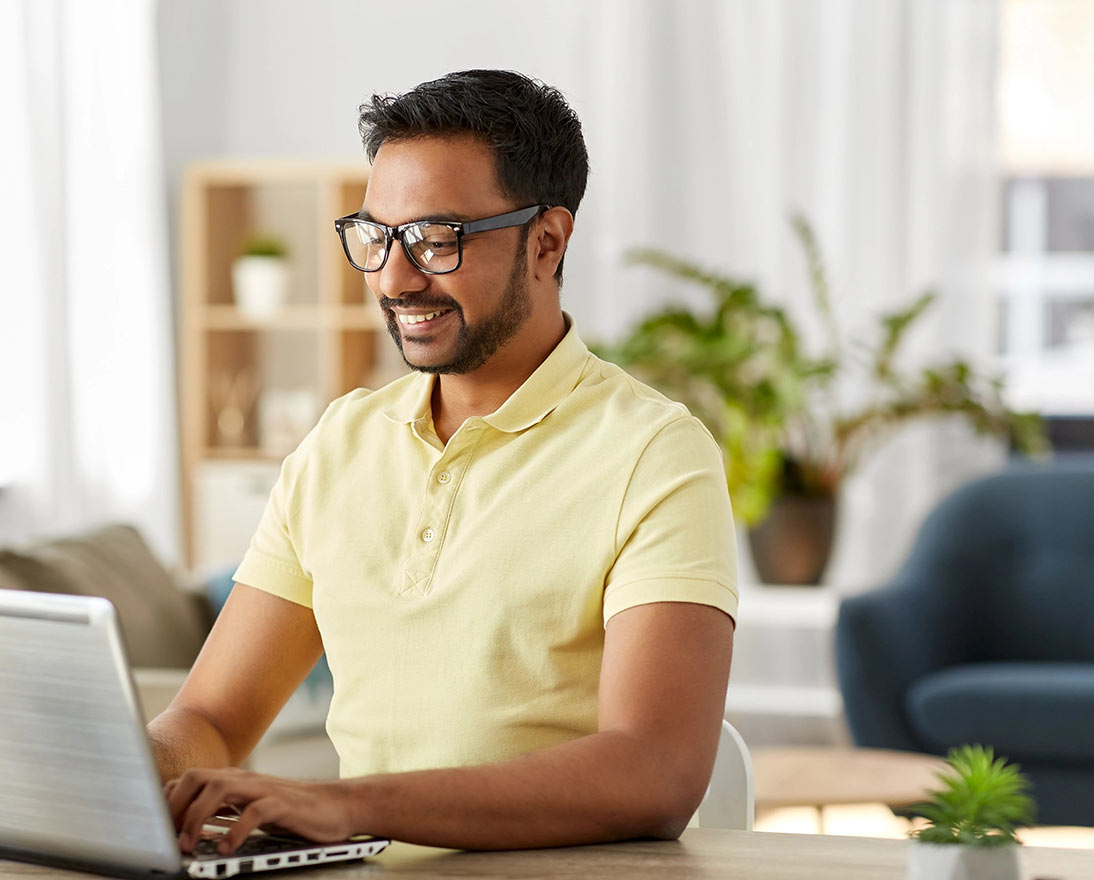 man tipping on laptop