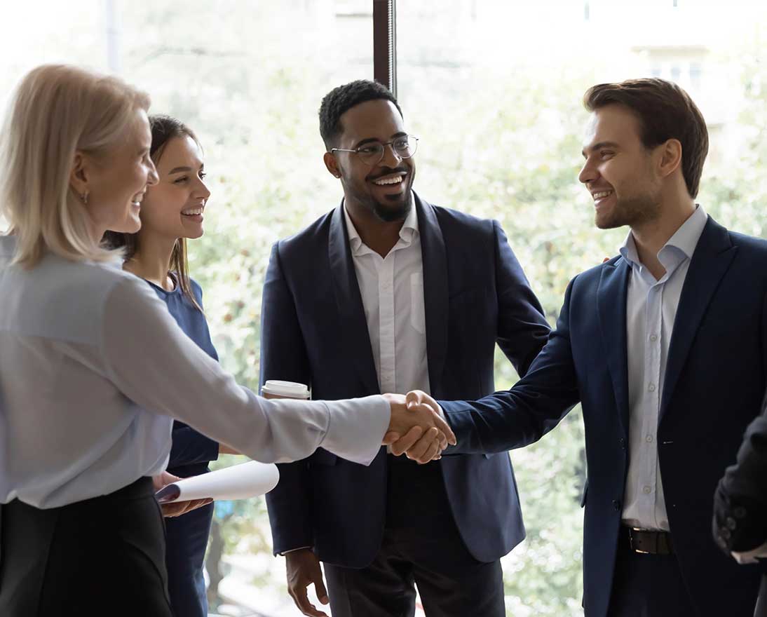 group of people are greeting each other