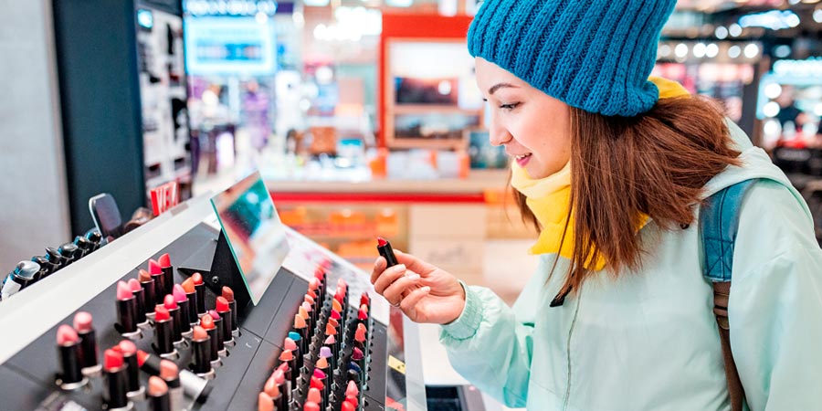Woman shopping for lipstick and other cosmetics in a store