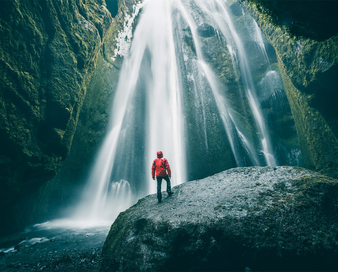 a person looking at a waterfall