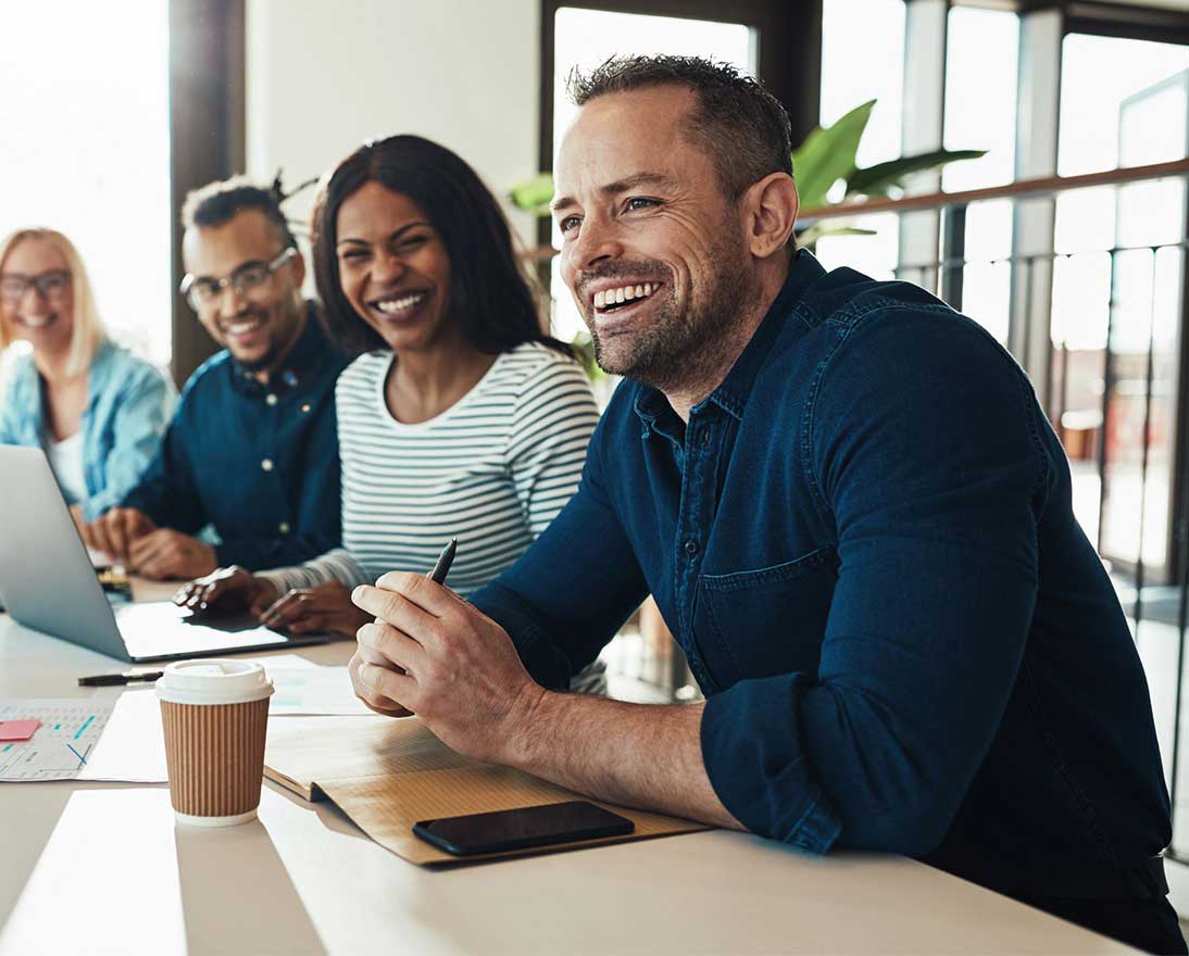 team laughing during meeting