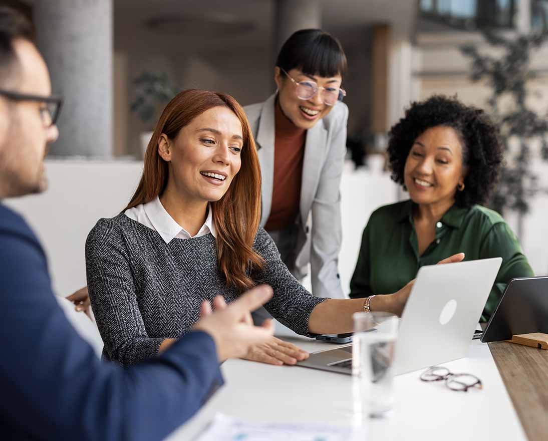 Office professionals exchange ideas during a collaborative meeting