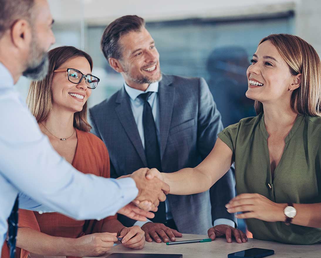 Business persons shaking hands on a meeting