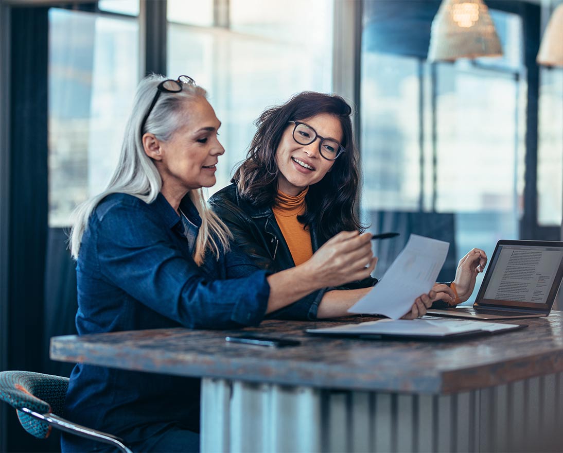 Two women working together at a desk