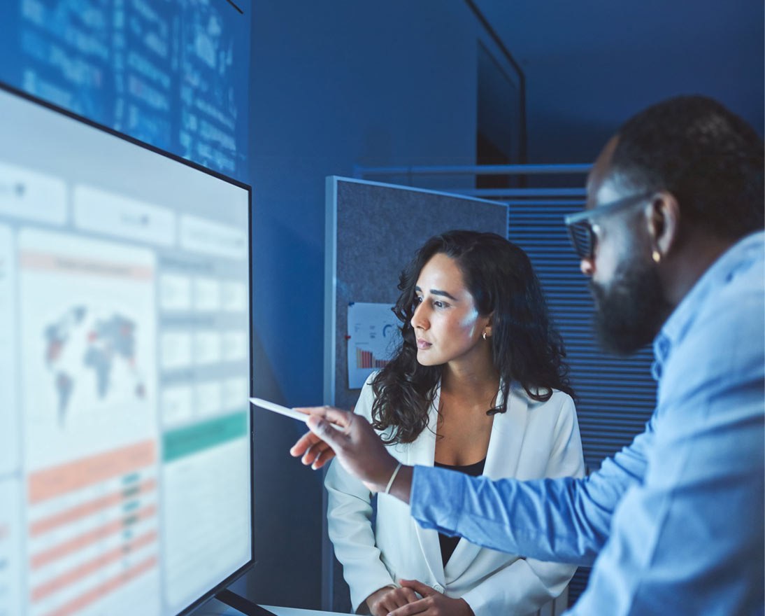 A team of multiethnic developers is meeting to review the data analysis of marketing from social media platforms