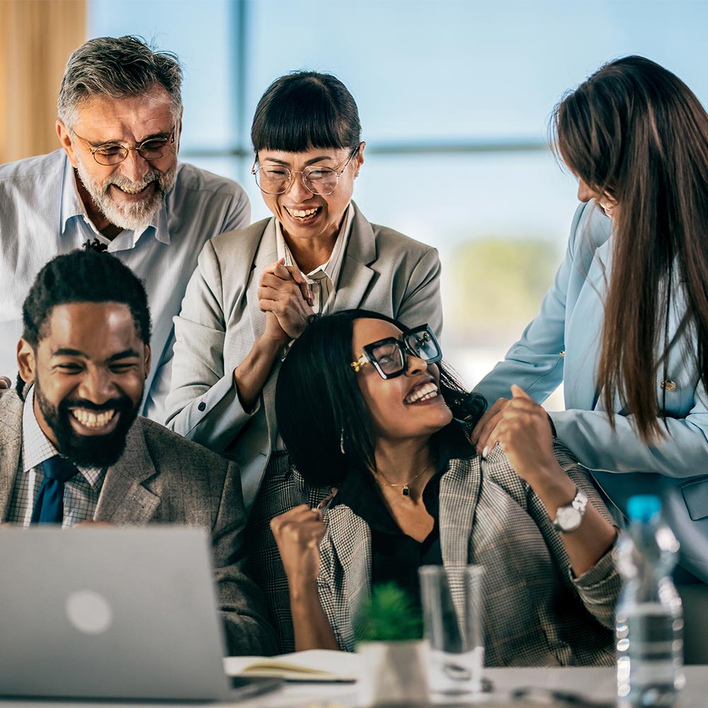 Business team celebrating success with raised hands 