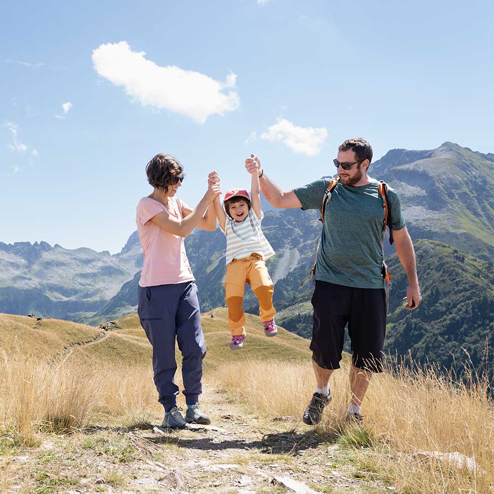 parents swinging their child