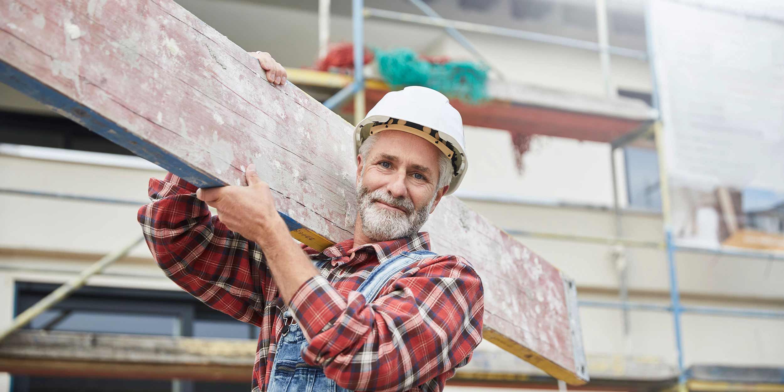 construction worker holding wood