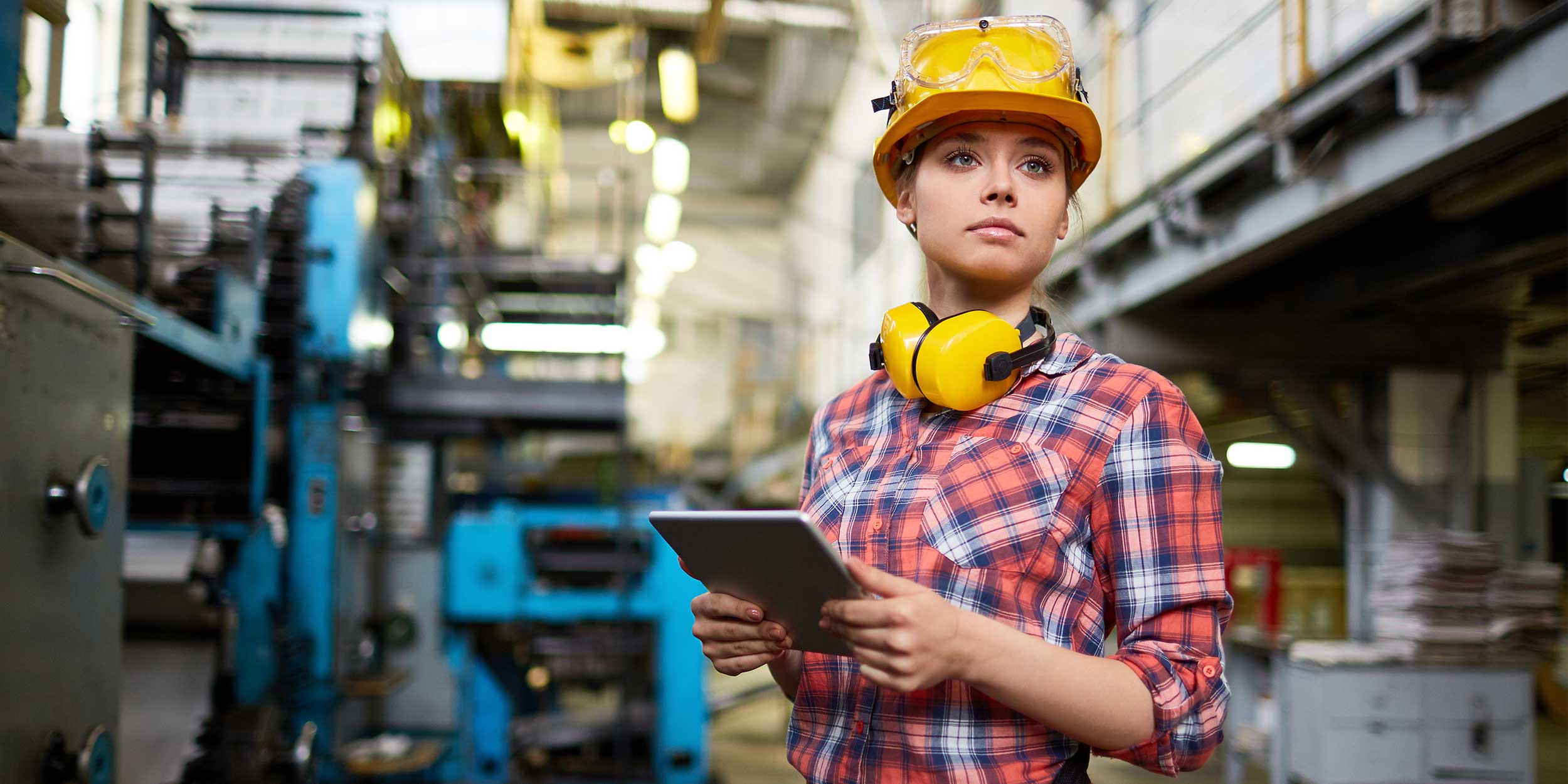 woman wearing protective equipment standing in factory