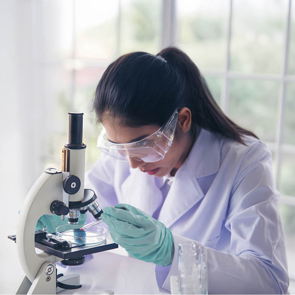 Woman scientist in lab look at science microscope medical test and research biology chemistry