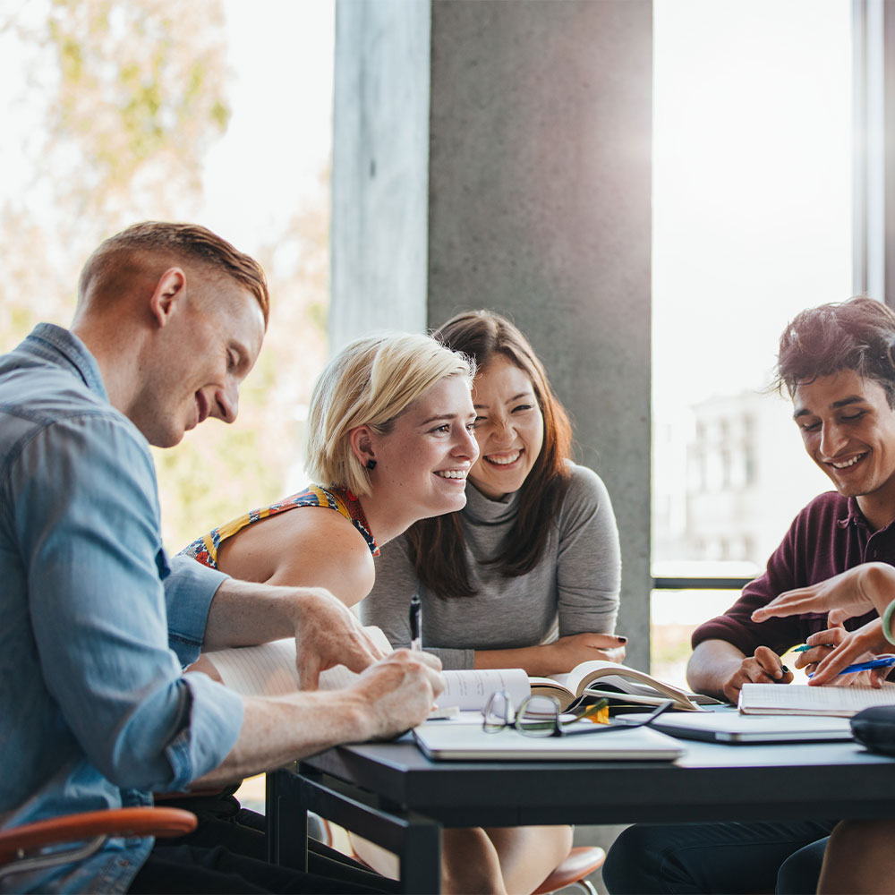 people sitting around a table and working together