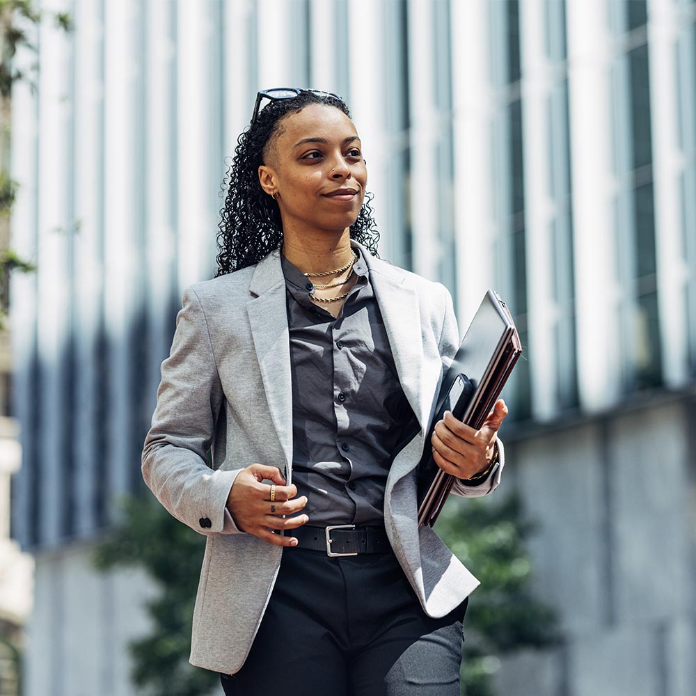 business woman walks with her folders