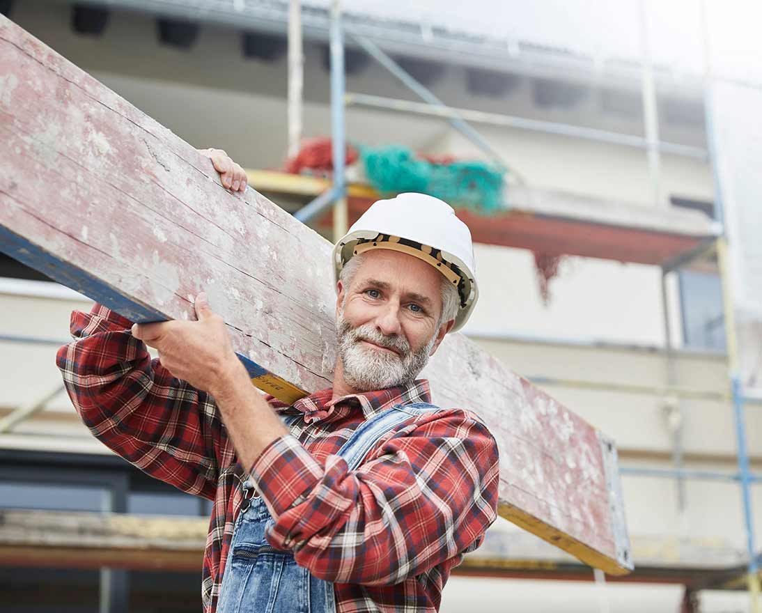 construction worker holding wood