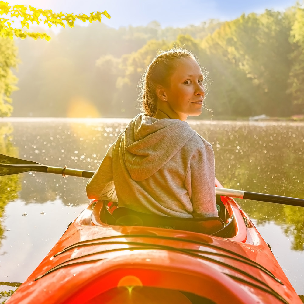 Woman on a kayak on a lake