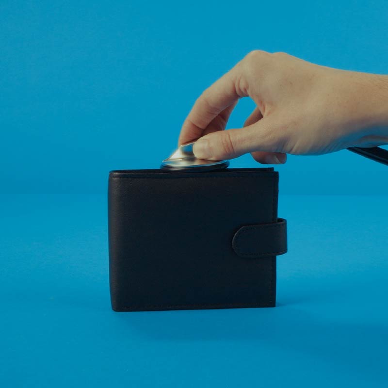 Hand putting money into a wallet