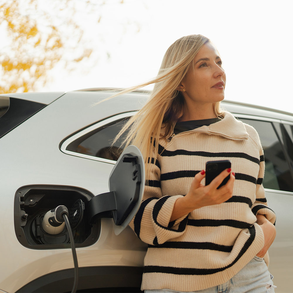 Woman charging her electric car