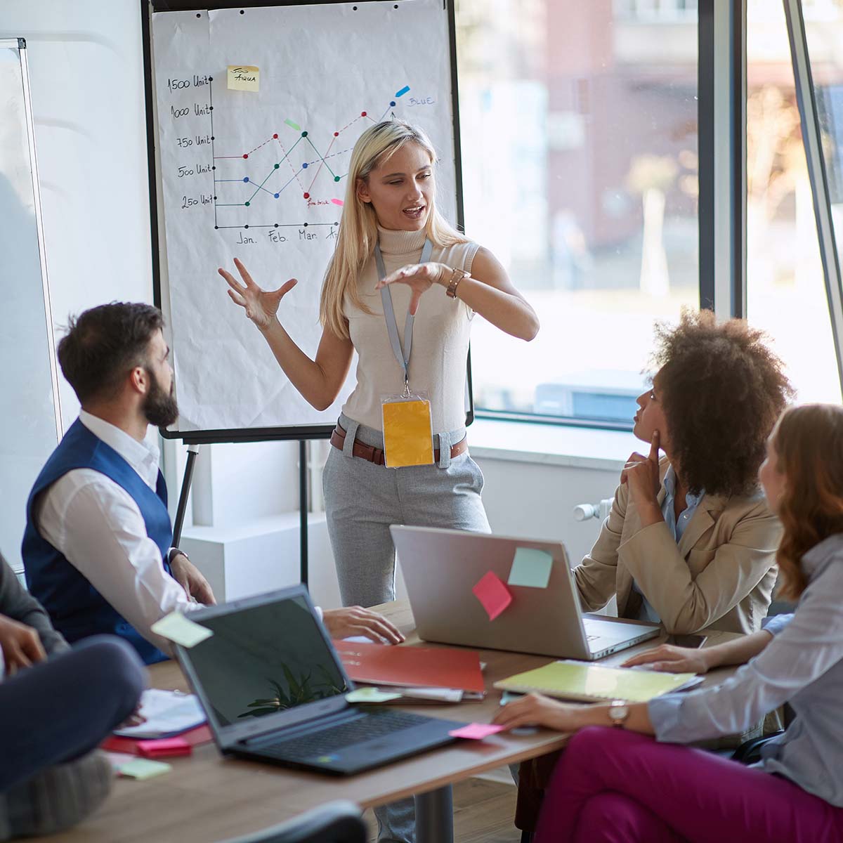 woman presenting in front of a team