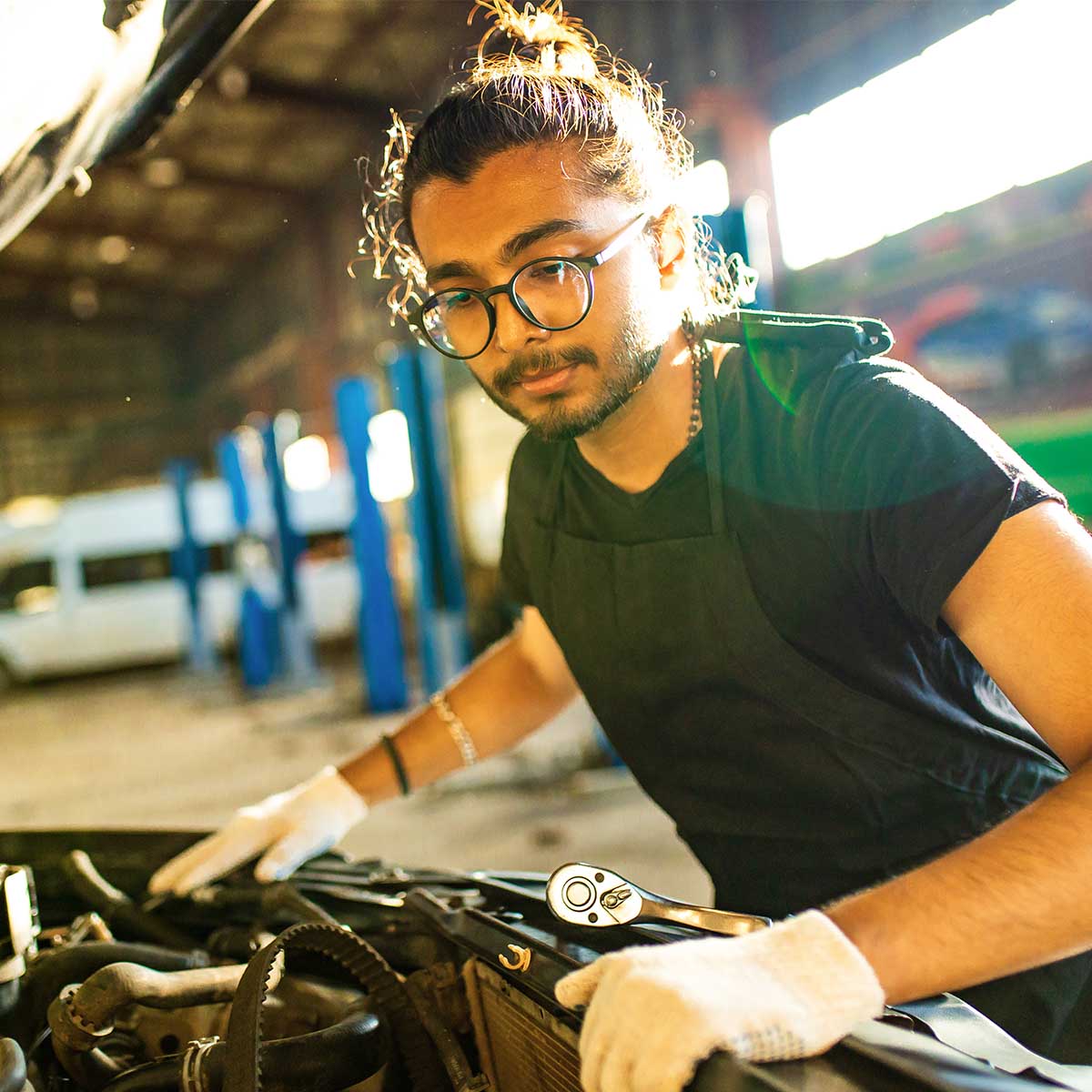 auto mechanic working indoors in car shop