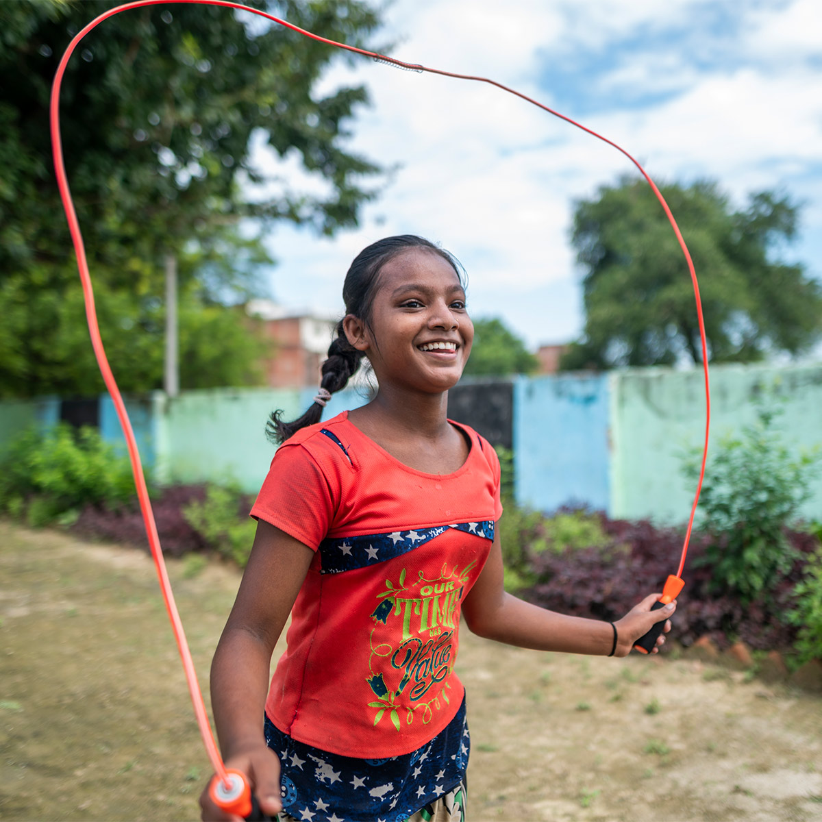 Smiling girl skipping