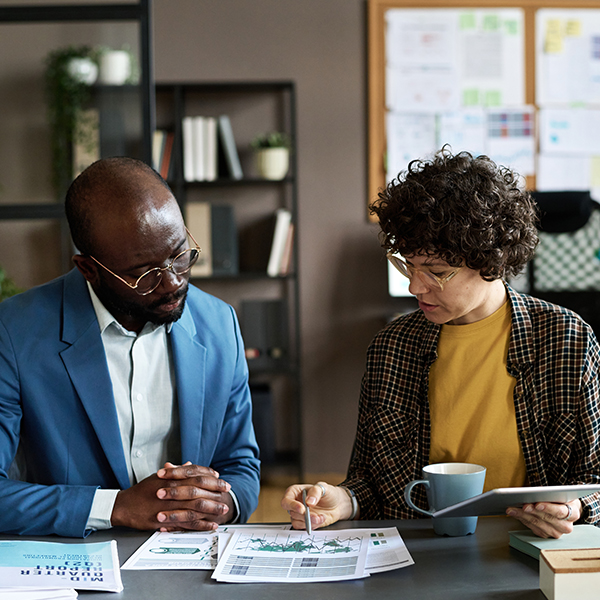 two people looking at documents together