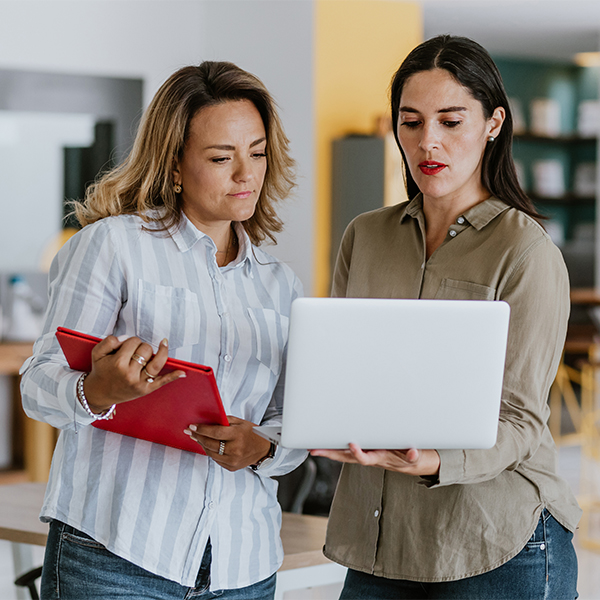 two women looking at a computer screen