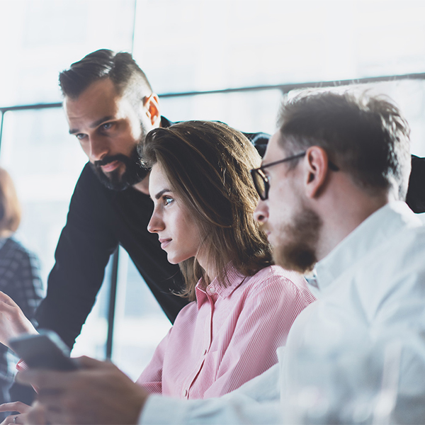 people working together in front of a computer