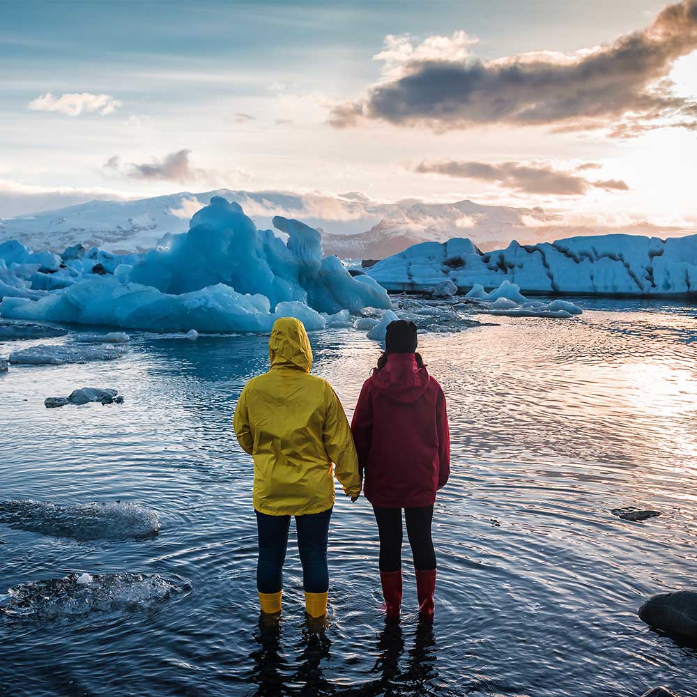 two people standing in the water