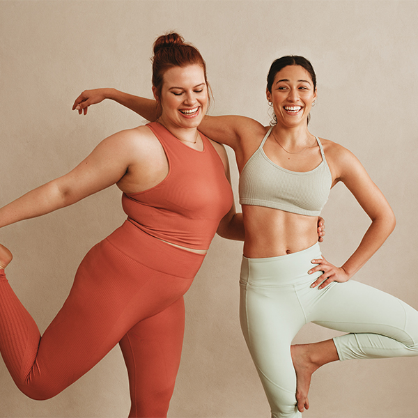 two women doing yoga together