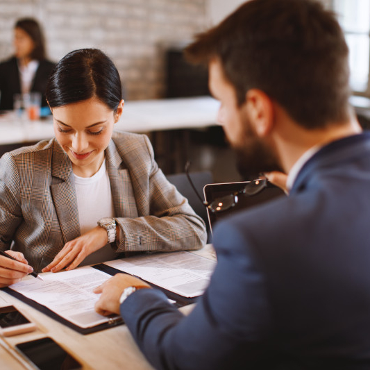 signing documents during business meeting