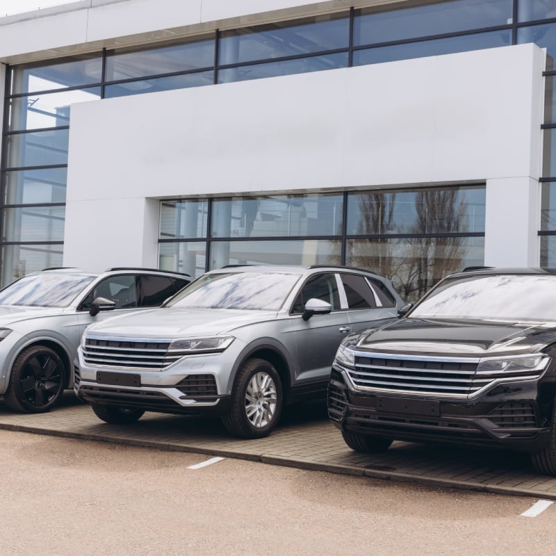 Three SUVs parked in front of dealership