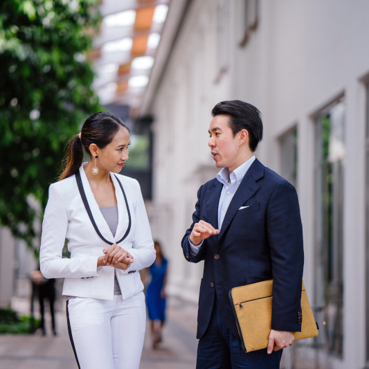 two people talking outside office