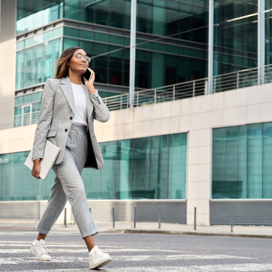 person walking outside modern office building