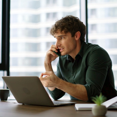 person working on laptop during call