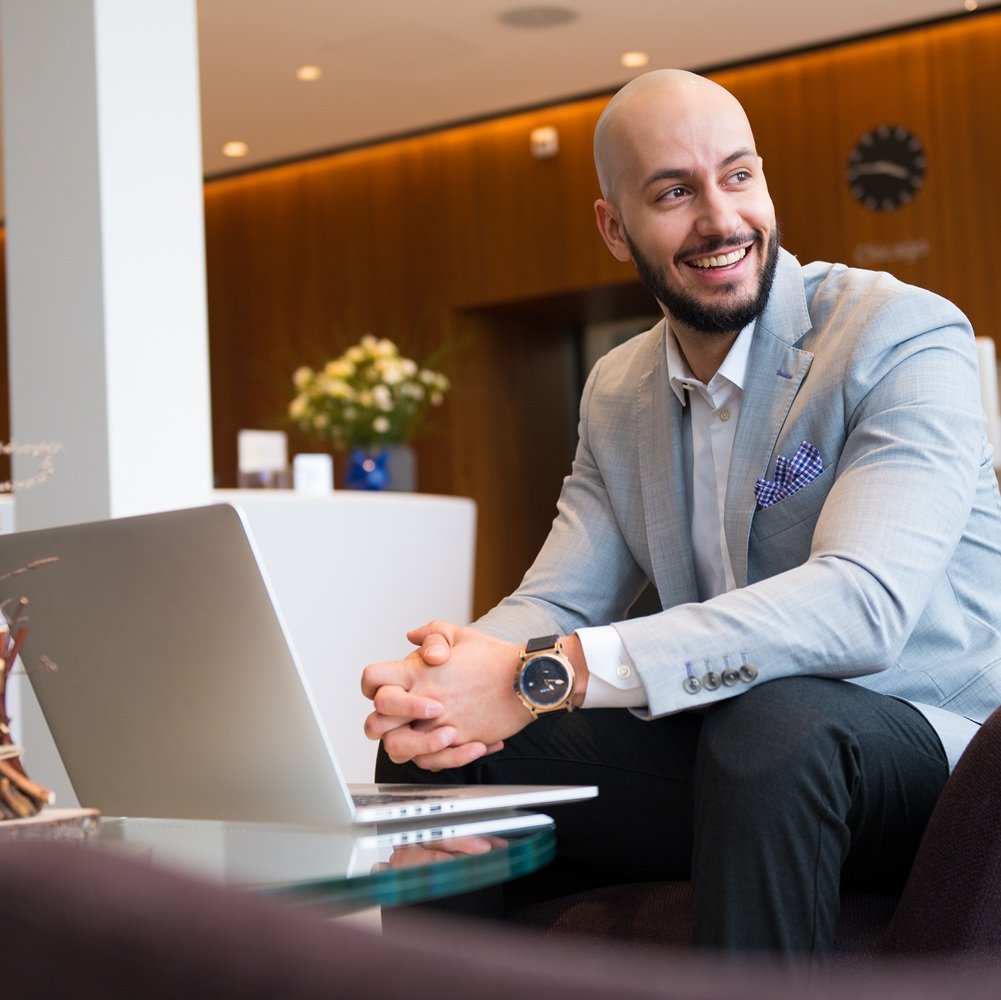man sitting and working on laptop