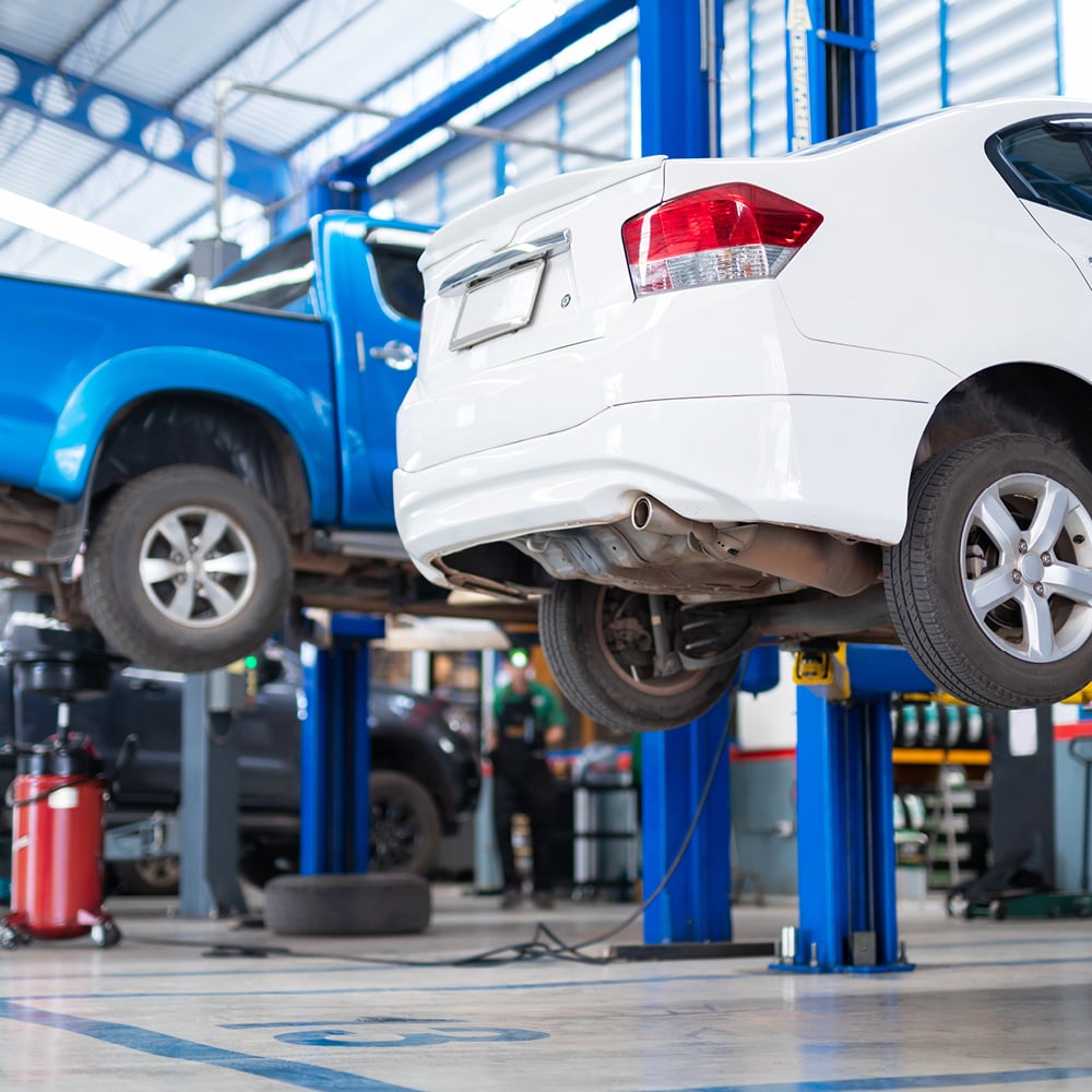 car and truck on lift