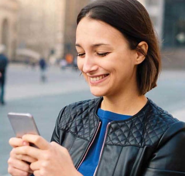 woman smiling with her phone