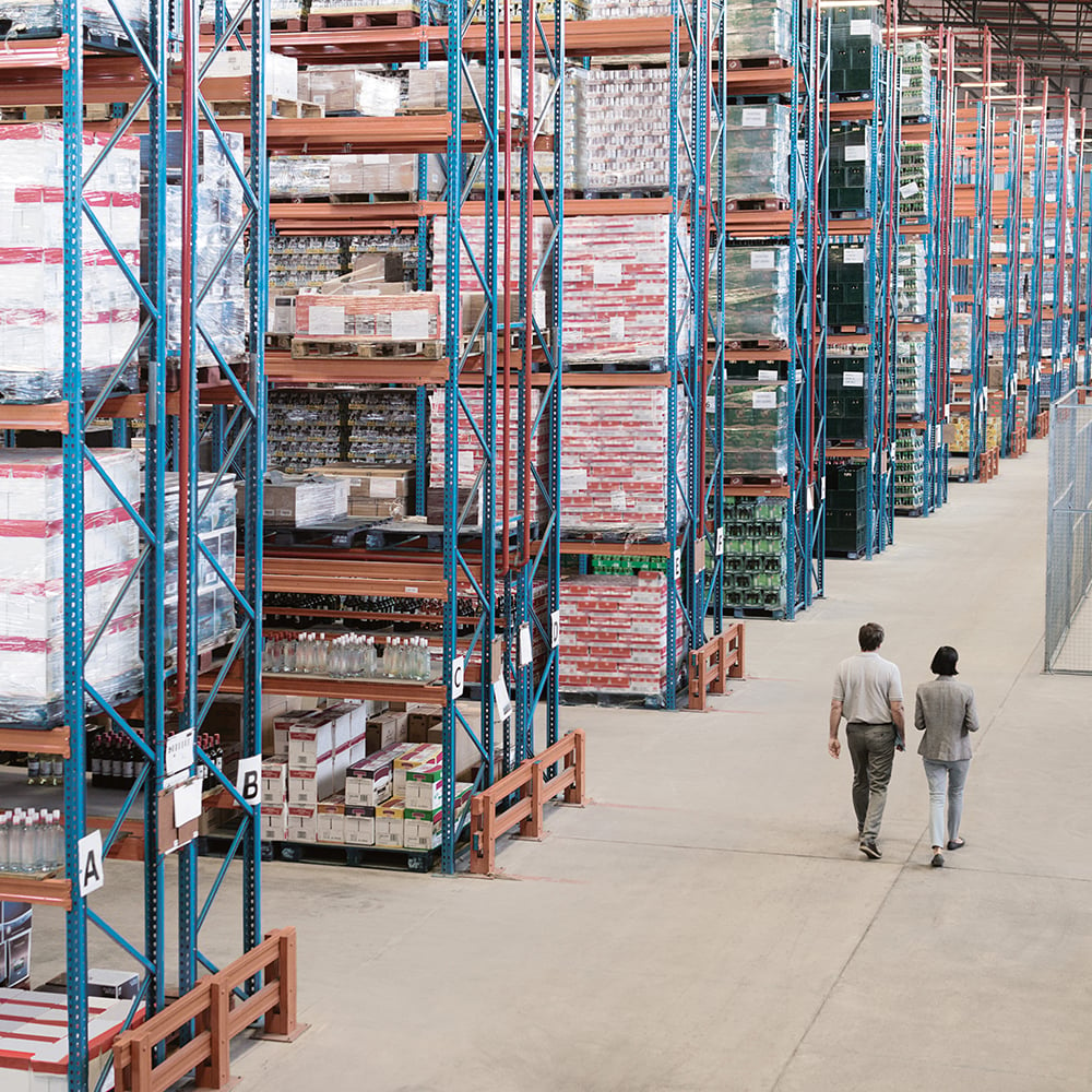 two men walking in a warehouse