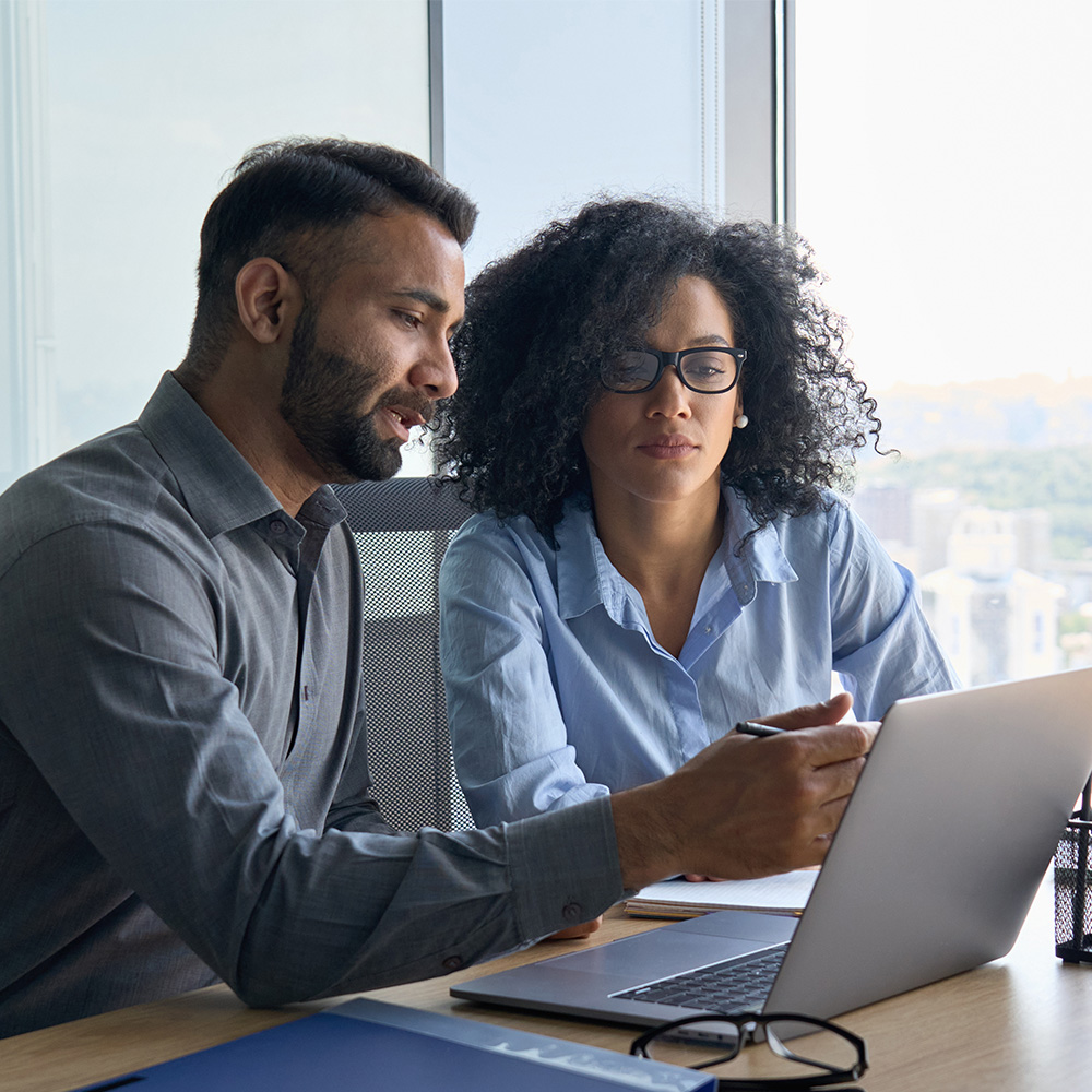 man and woman looking at a computer screen