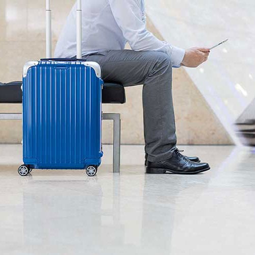 man with blue luggage