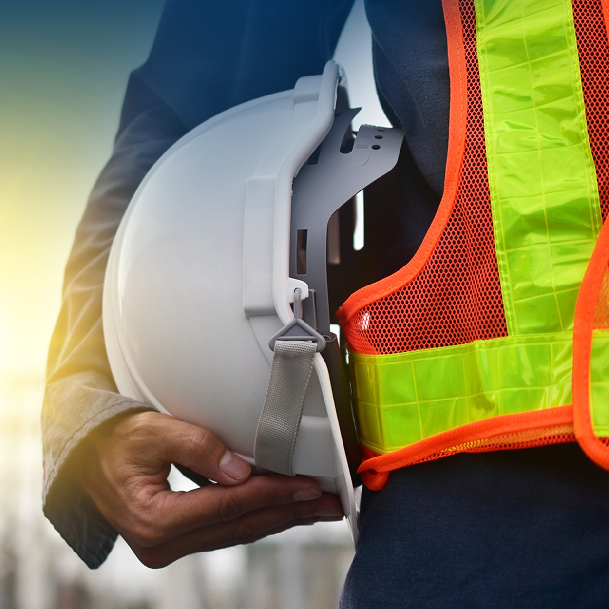 worker holding hardhat