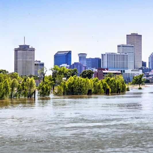 Flooded urban area with high-rise buildings in the background.