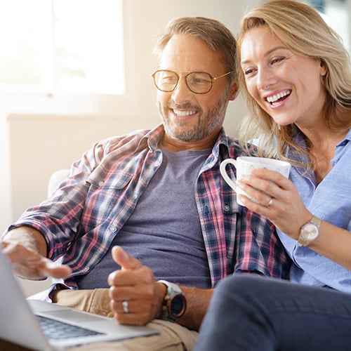 man-and-woman-looking-at-laptop-500X500